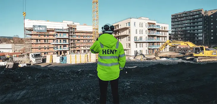 Hent worker in front of construction site